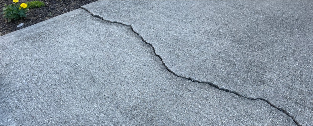 Cracked and uneven concrete sidewalk