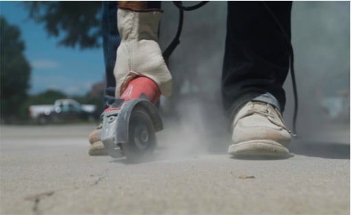 Concrete saw preparing cracked concrete for sealant