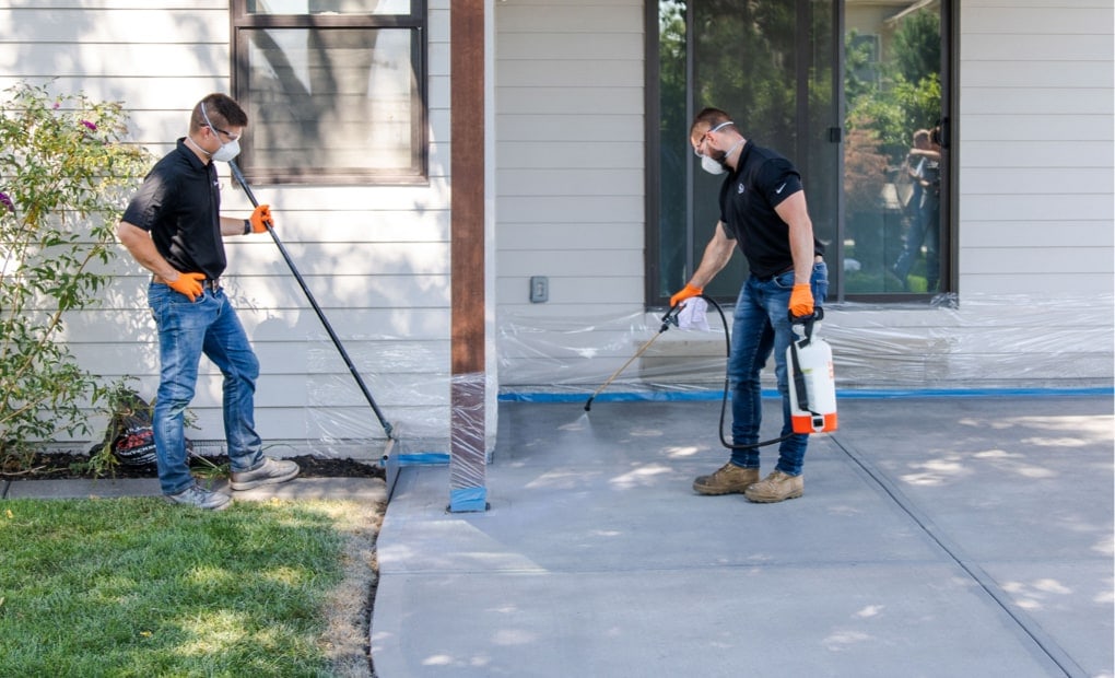 A team of LevelUp technicians applying DecoShield to concrete patio