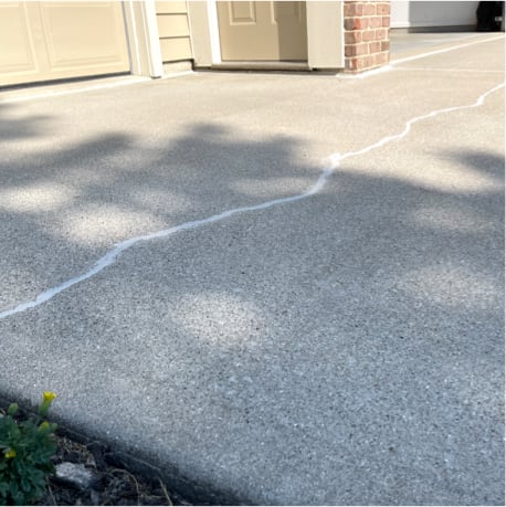 An example of a cracked driveway filled with a concrete crack sealant in Indianapolis.