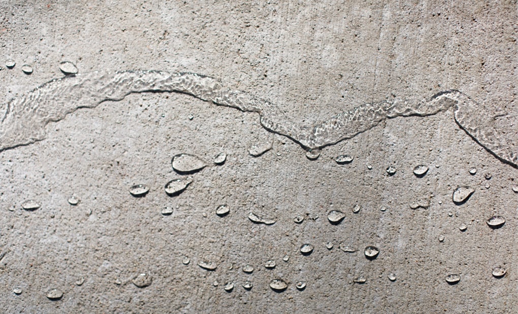 Result of SealantPro application showing water beading on concrete surface