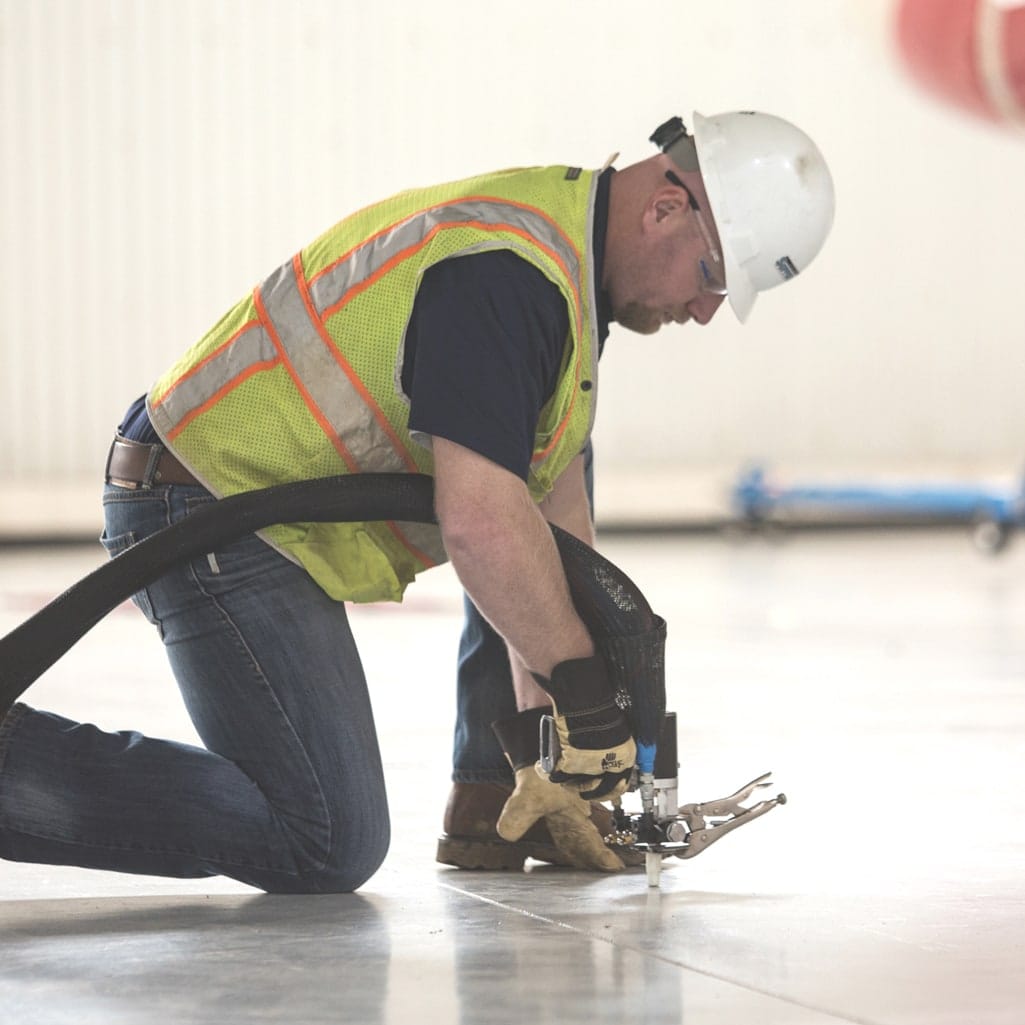 A LevelUp technician injecting PolyLevel into a concrete slab