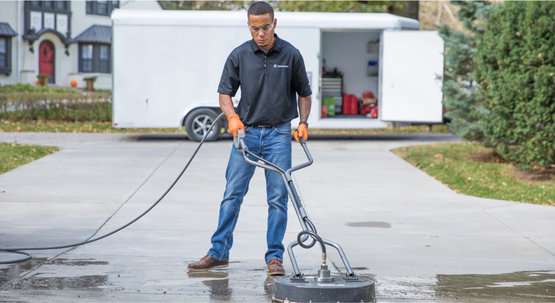 LevelUp technician powerwashing a concrete driveway