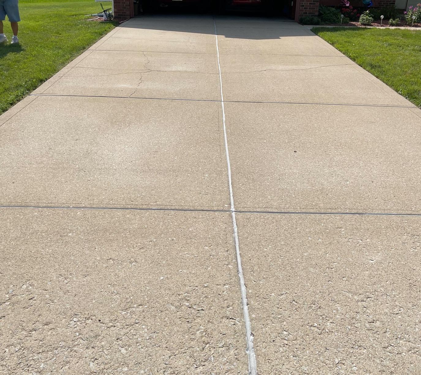 Driveway after power washing and sealing