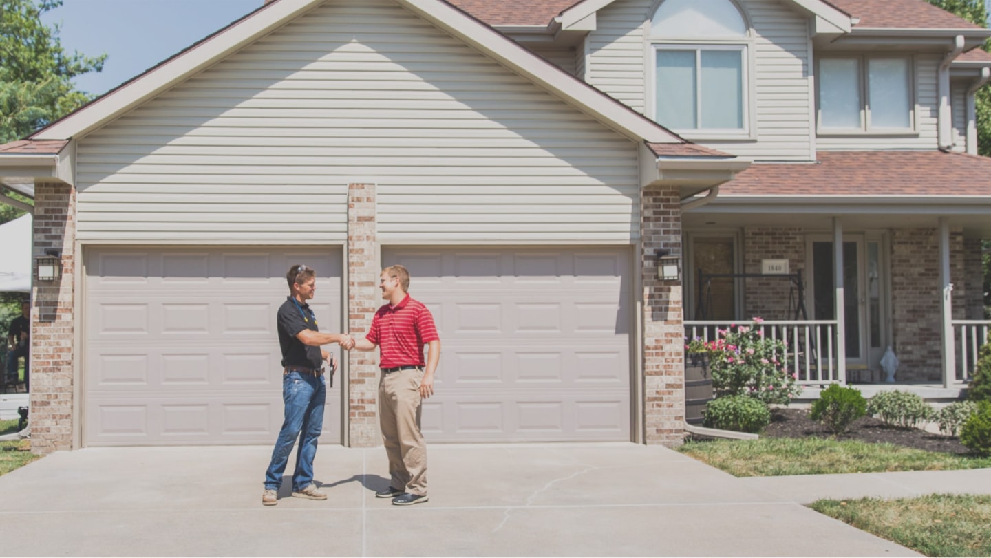 A LevelUp technician shaking hands with residential homeowner