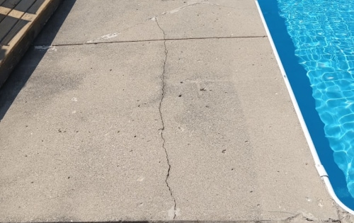 Cracked pool deck before repair