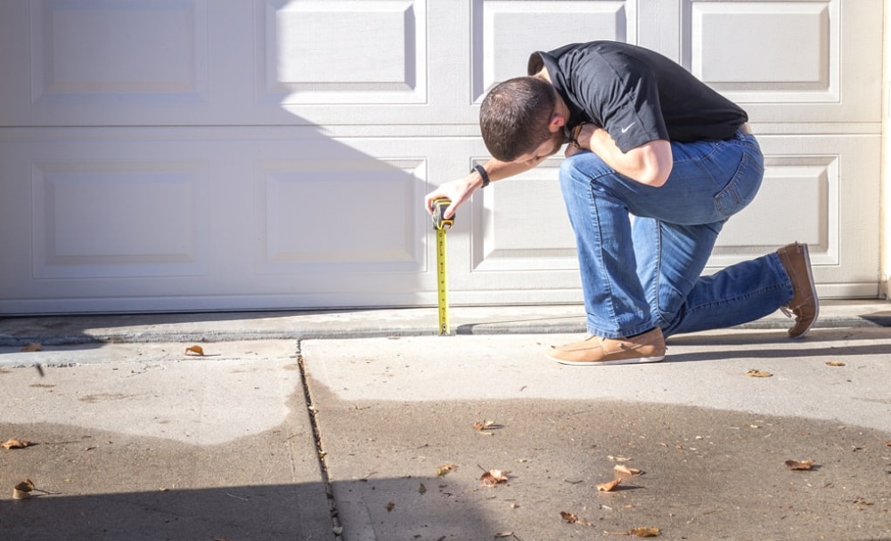 A LevelUp technician measuring the levelness of a driveway