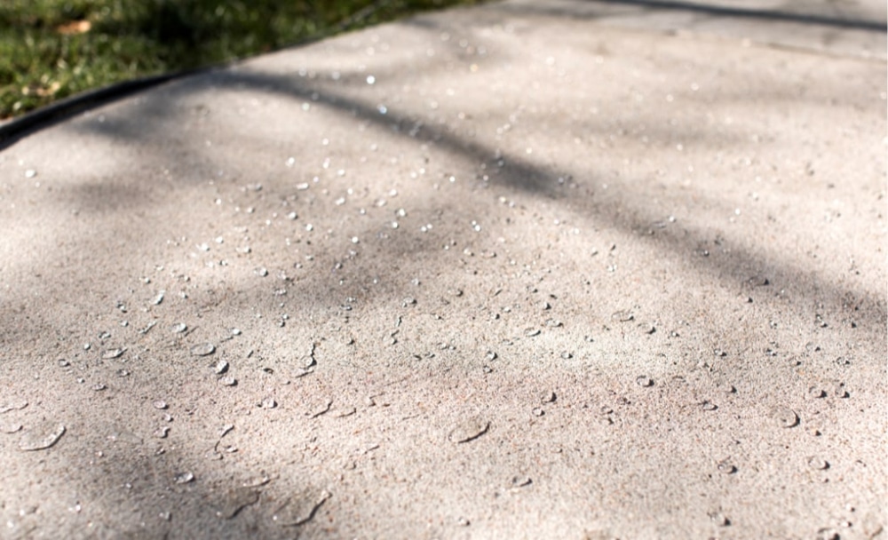 Example of water beading on a concrete driveway sealed with SealantPro