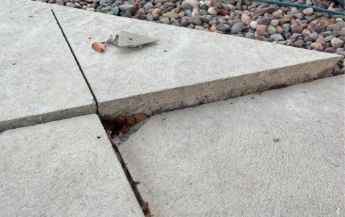 Uneven and sunken concrete sidewalk