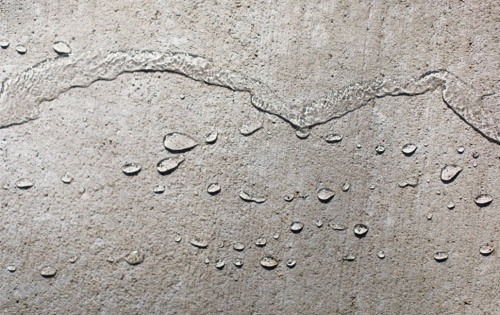 Result of SealantPro application showing water beading on concrete surface