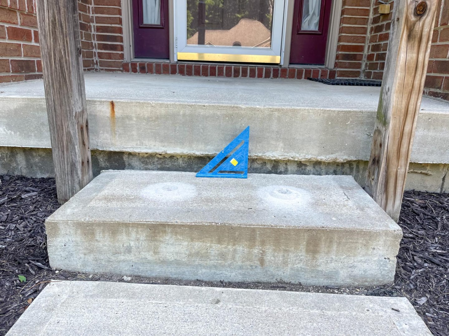 Sunken front step before lifting and repair