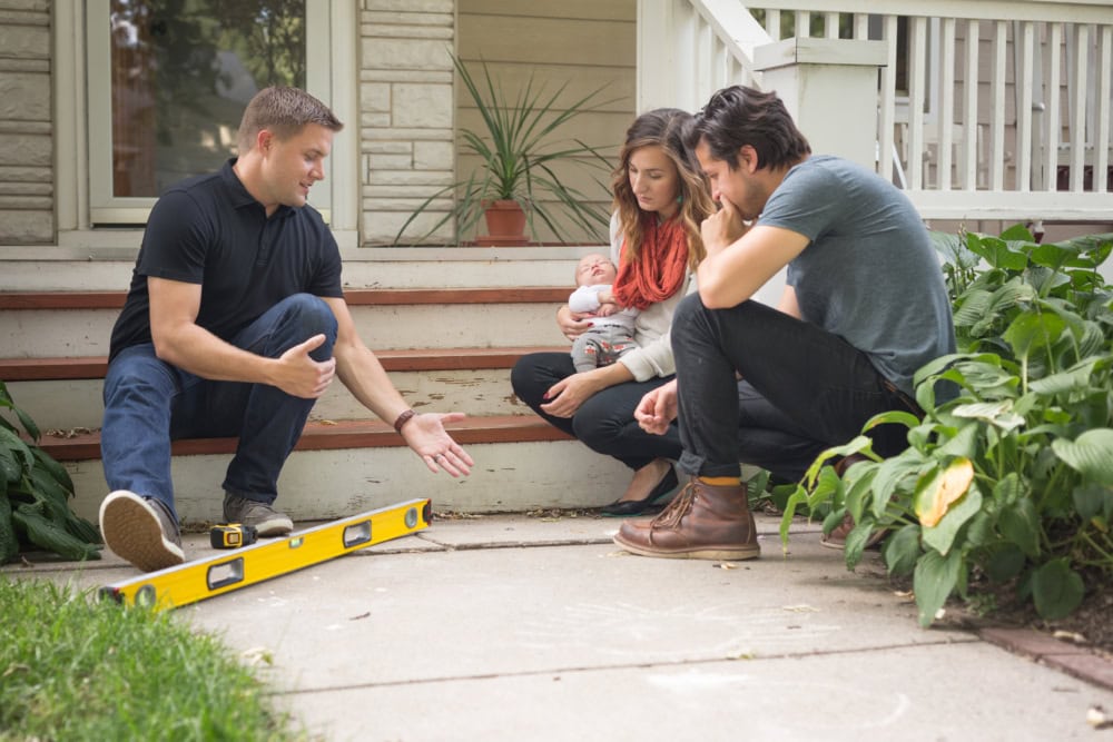 Levelup concrete expert meeting with a family to discuss their concrete lifting needs.