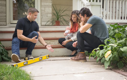Levelup concrete expert meeting with a family to discuss their concrete lifting needs.